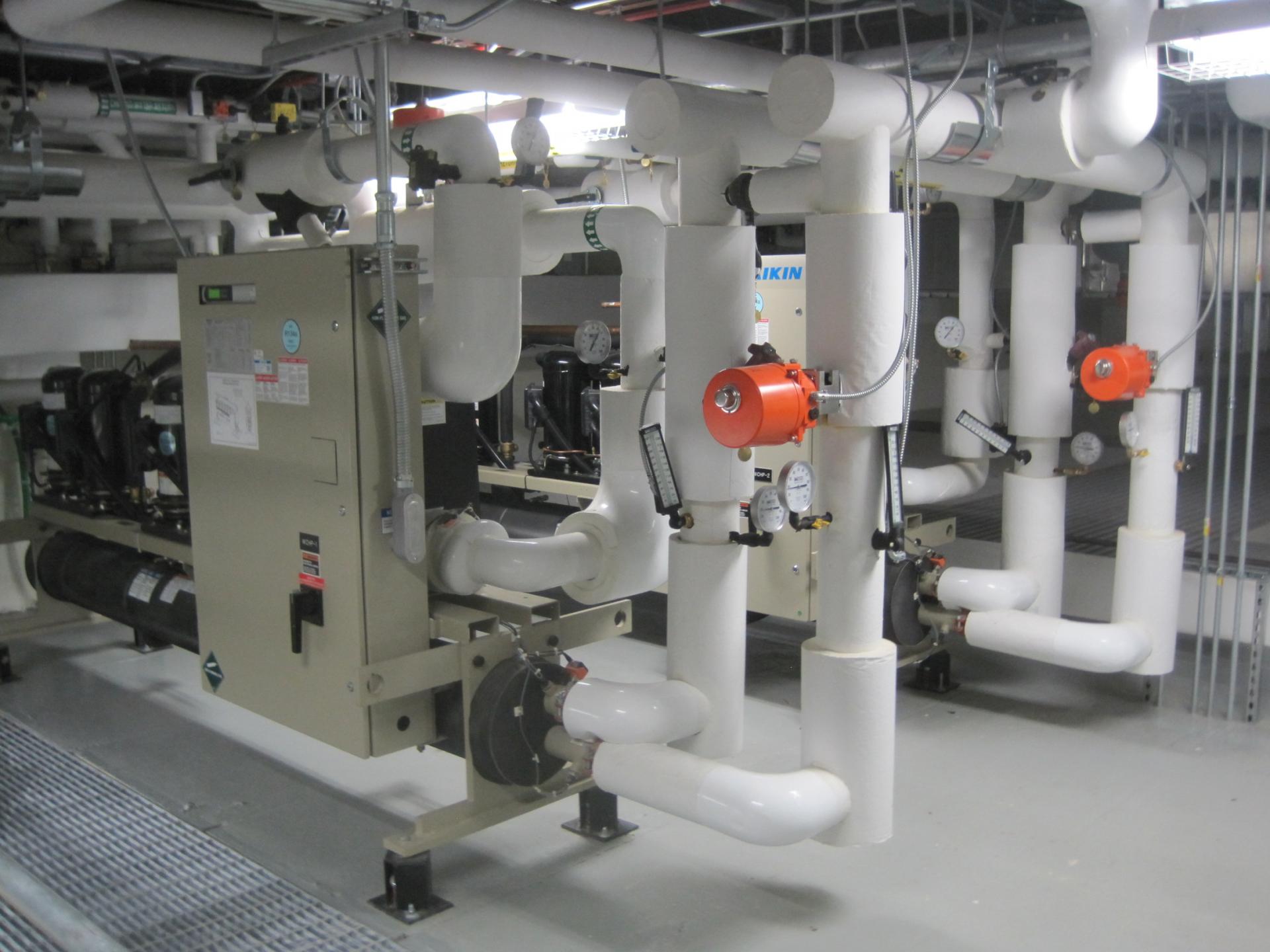 Heat is extracted from the chilled water loop, providing hot water for heating.