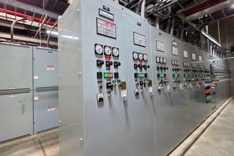 New control switchgear for upgraded 14-generator plant, with generator paralleling switchgear behind.