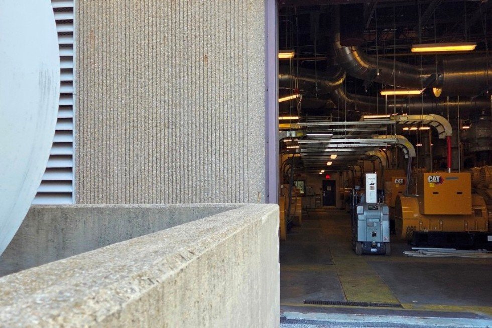 AST in concrete containment with generator plant beyond (roll-up door normally closed and secured). 