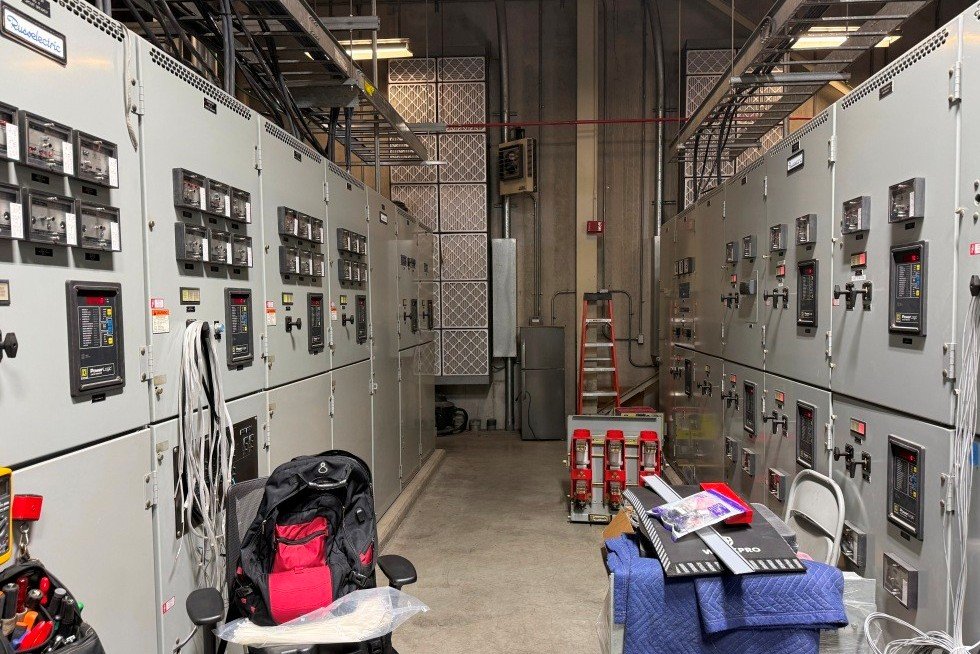 New service entry / utility switchgear  (l) and generator paralleling switchgear (r) during final stages of assembly. Spare breaker in background, just in case. 