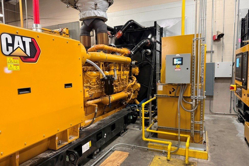  Skid mounted generator on vibration isolators with radiator shroud at exterior exhaust plenum. Day tank connected to pit mounted supply and return fuel distribution lines. All prepped and ready for testing and commissioning. 