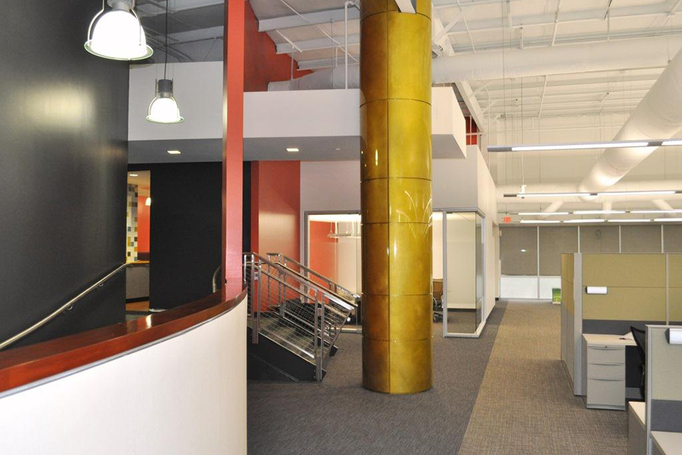 Natural light bathes the open office area, which is free of walls and obstructions