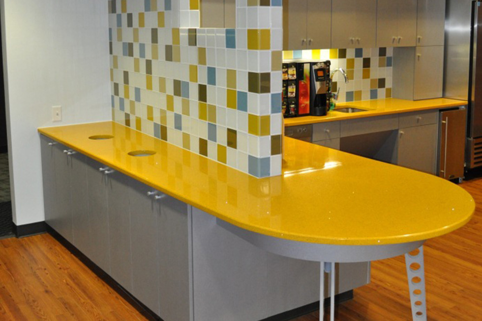 Colored glass tiles randomly blended within a white glass tile field to brighten up the space 