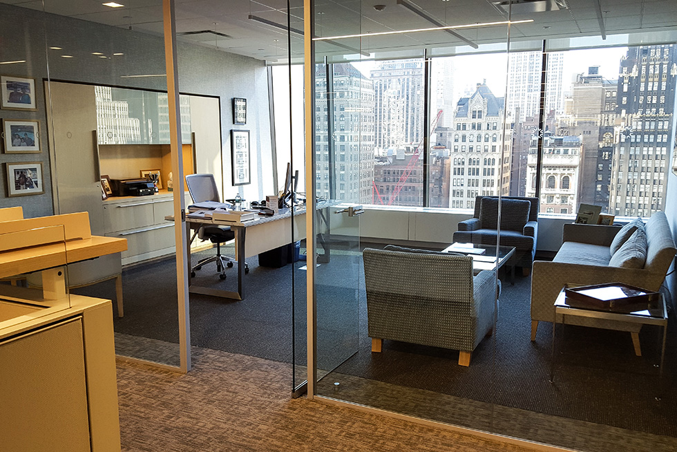 Executive office configured with soft seating for team meetings. 