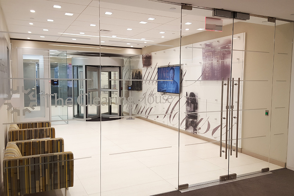 The public lobby area includes comfortable seating for waiting or an informal meeting ahead of inner secure office spaces