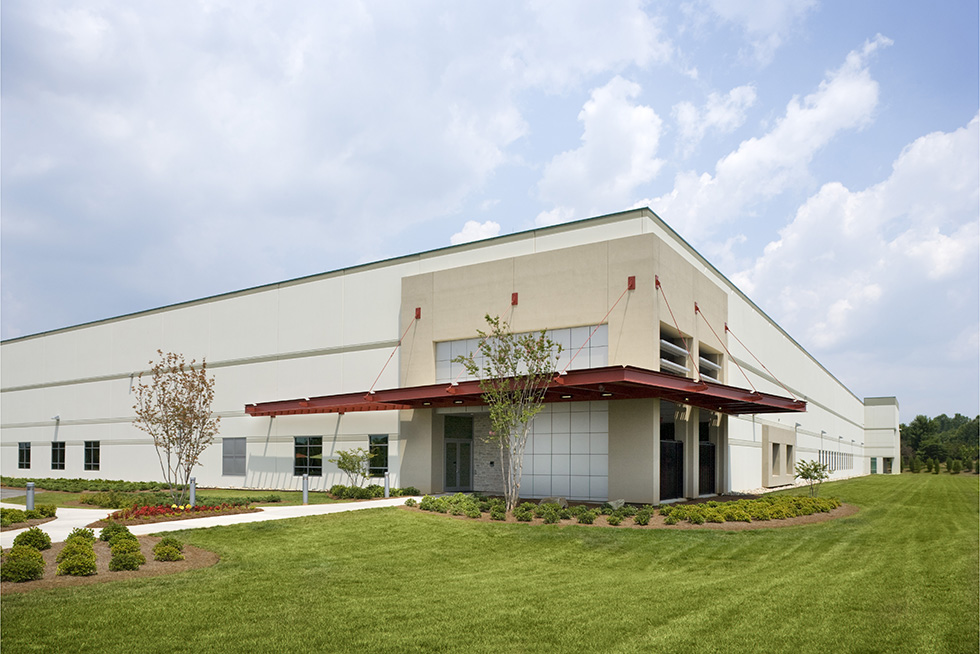 The entry to the secure facility is demarcated by an overhead steel canopy