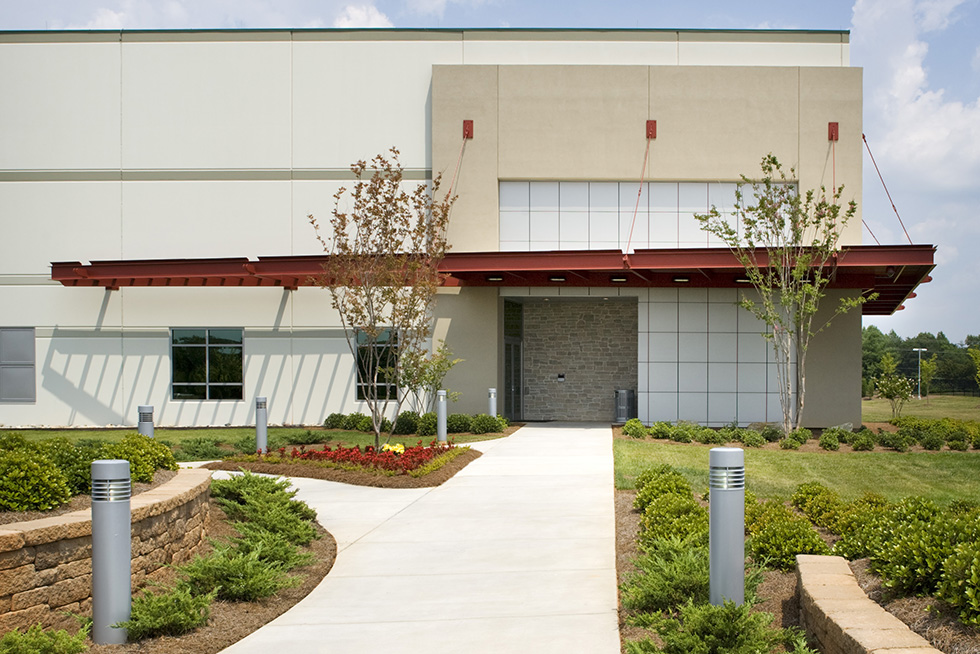 Security features include earthen berm, stone walls, and landscape elements