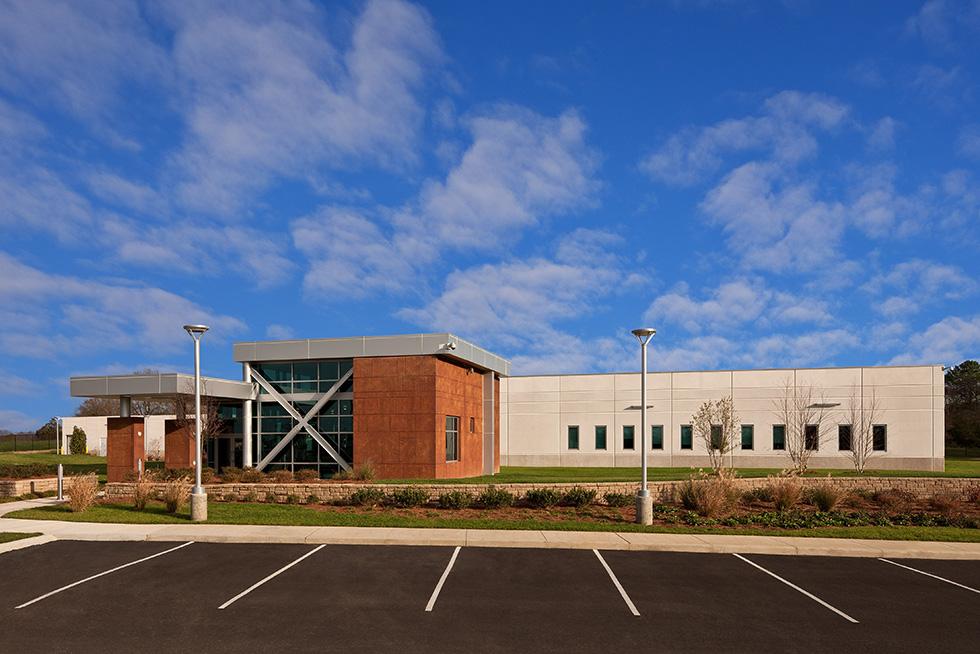 Site security is enhanced by natural features including berms, landscape planters, and stone walls.