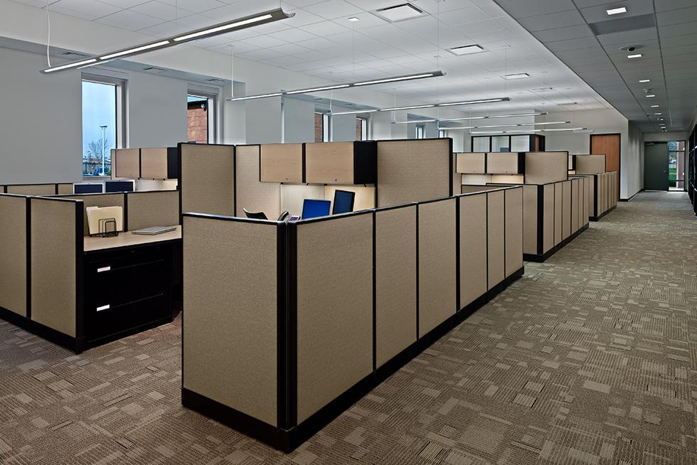 Glazed openings punched into the hardened precast walls provide natural light for the administrative and support staff.